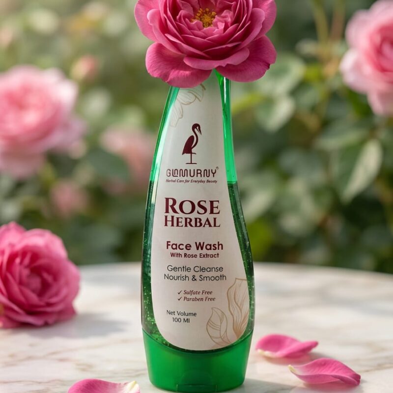 GLAMURNY Rose Herbal Face Wash 100ml bottle with fresh pink rose flower and petals, natural rose extract herbal face wash for gentle cleansing and smooth glowing skin.
