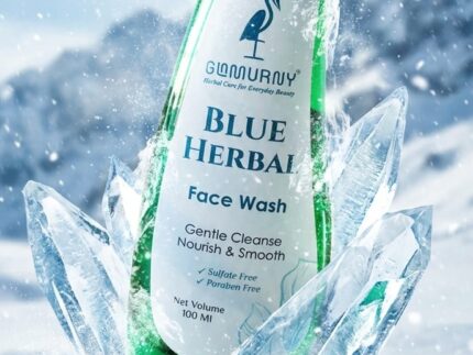 GLAMURNY Blue Herbal Face Wash bottle surrounded by ice crystals and snow, representing refreshing herbal skincare, gentle cleansing and cool skin hydration.