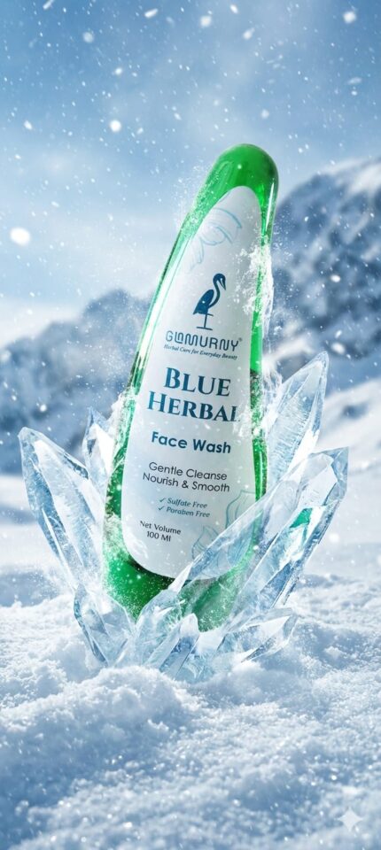 GLAMURNY Blue Herbal Face Wash bottle surrounded by ice crystals and snow, representing refreshing herbal skincare, gentle cleansing and cool skin hydration.